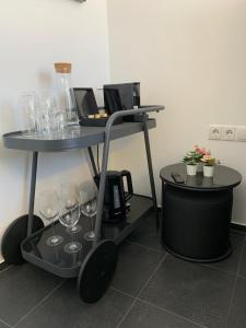 a table with wine glasses on top of it at Motel by Maier Feldkirch - kontaktloser Check-in in Feldkirch