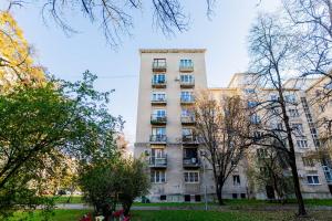 an apartment building with trees in front of it at Újbuda Rest Apartment With Air Condition and Balcony in Budapest