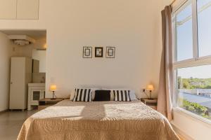 a bedroom with a large bed and a large window at Superior Nevado Penthouse San Rafael in San Rafael