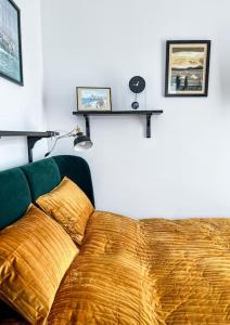 a bedroom with a bed with two shelves on the wall at Art deco studio in Old town in Bratislava