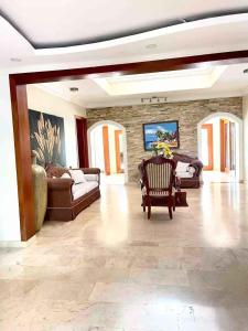 a large living room with couches and a stone wall at VILLA I-31 capacidad para 20 personas in Paraíso