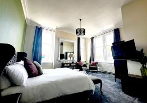 a bedroom with a bed and a living room at Station Lounge & Rooms in Clitheroe