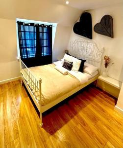 a bedroom with a bed with two hearts on the wall at H4: Fantastic Apartment - 100m from Piccadilly Circus in London