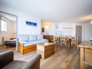 a living room with a couch and a table at Appartement 8 pers. Peyragudes avec piscine et proche des pistes - FR-1-695-27 in Germ +6 photos