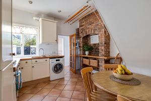 a kitchen with a table with a bowl of bananas on it at Gamul Place - Quiet City Centre in Chester