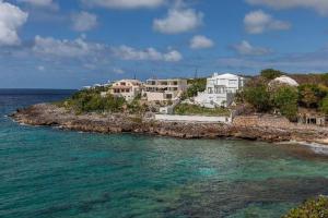 a group of houses on an island in the ocean at Anguilla Sunset Beach House in Crocus Hill