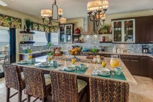 a kitchen with a large island with a breakfast bar at Anguilla Sunset Beach House in Crocus Hill