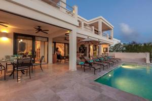 a villa with a swimming pool and a patio at Anguilla Sunset Beach House in Crocus Hill