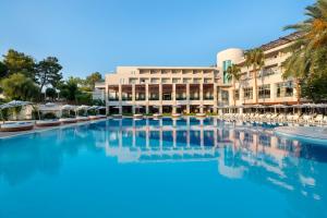 a large swimming pool in front of a hotel at Rixos Premium Tekirova - The Land of Legends Access in Tekirova
