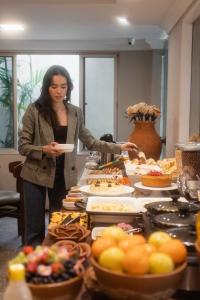 a woman standing in front of a buffet of food at Fortaleza Mar Hotel in Fortaleza