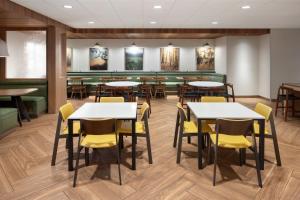 a dining room with tables and chairs at Fairfield Inn & Suites by Marriott West Kelowna in West Kelowna