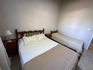 Katil atau katil-katil dalam bilik di Quinta Familiar con Piscina