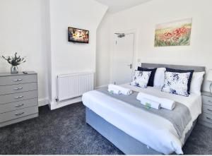 a bedroom with a large bed and a dresser at Burnley Terraced House by BEVOLVE - Free Parking 3 in Burnley