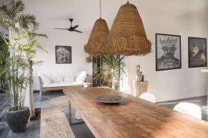 a living room with a wooden table and chairs at Villa Sophia Seminyak in Seminyak