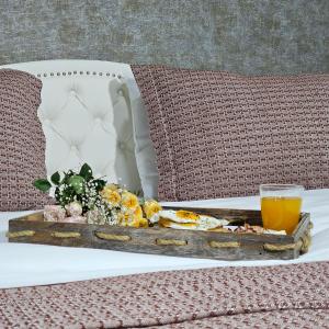 a table with a tray of food and a glass of orange juice at Memory basket in Kutaisi