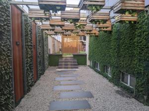 a walkway with a green wall and stairs at BON Hotel Nest Ibadan in Ibadan