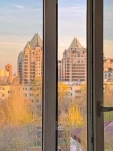 a window with a view of a city at Уютная студия в скандинавском стиле в центре in Astana