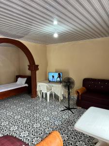 a living room with a table and a couch at Yogi Guesthouse Most Affordable, Decent and Nearest accommodation near Airport with Wifi and hot showers in Freetown