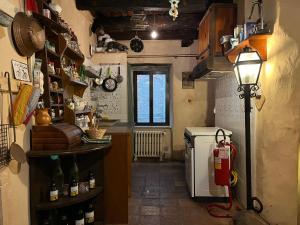 a small kitchen with a refrigerator and a lamp at La Preta Nera in Giuliano di Roma
