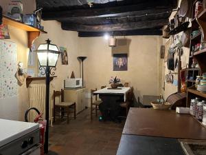 a kitchen with a table and a dining room at La Preta Nera in Giuliano di Roma