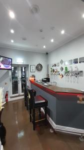 a bar in a restaurant with two chairs and a counter at Astala Lodge in Bangor