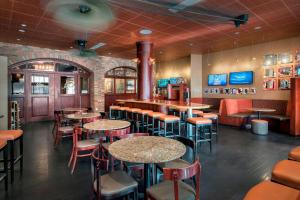 a restaurant with tables and chairs and a bar at Fairfield inn & Suites by Marriott Baltimore Downtown/Inner Harbor in Baltimore