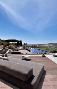 a man is sitting next to a swimming pool at Buahjar Boutique Home Apartment in Agrigento +119 photos