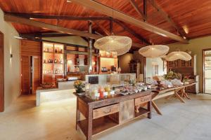 a large kitchen with a long table in a room at Hotel Ponta do Madeiro in Pipa