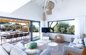 a living room with a couch and a dining room at The Beach House in Olmeto