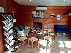 a living room with a couch and chairs and a fireplace at Camping de Collonges-la-Rouge in Meyssac