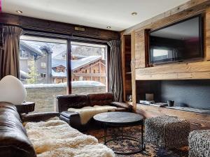 a living room with a couch and a large window at Appartement Val-d'Isère, 4 pièces, 6 personnes - FR-1-518-87 in Val-d'Isère
