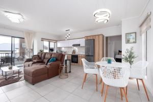 a living room with a couch and a table and chairs at Ballito Hills Luxury Apartments in Ballito