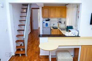 a small kitchen with a table and a staircase at Sturdy Stays KAHAWA WEST in Nairobi