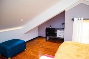 a living room with a blue couch and a desk at Sturdy Stays KAHAWA WEST in Nairobi