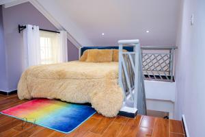 a bedroom with a bunk bed with a rainbow rug at Sturdy Stays KAHAWA WEST in Nairobi