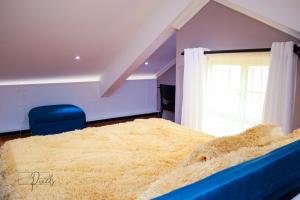 a bedroom with a large bed with a window at Sturdy Stays KAHAWA WEST in Nairobi