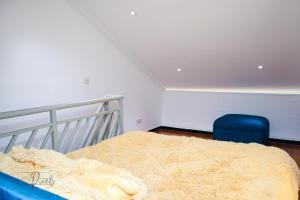a bedroom with a bed and a blue chair at Sturdy Stays KAHAWA WEST in Nairobi