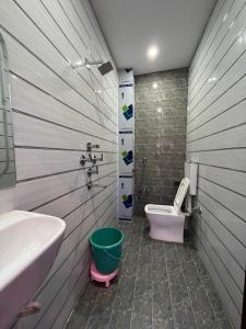 a bathroom with a sink and a toilet at Baba Vishwanath Residency in Varanasi