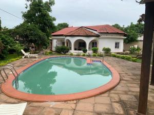 a swimming pool in front of a house at Tilo Lodge in Bathurst