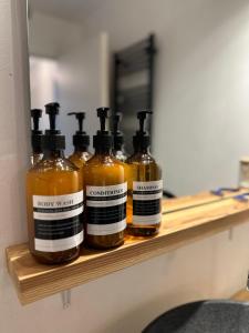 a shelf with four bottles of honey on it at Le Balcon de Léo - Proche centre & Parc des expos in Bordeaux
