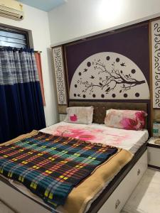a bedroom with a large bed with a large headboard at Udaipur Stays 2 in Udaipur