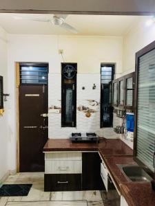a bathroom with a sink and a clock on the wall at Udaipur Stays 2 in Udaipur