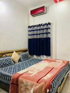 a bedroom with a bed and a window at Udaipur Stays 2 in Udaipur