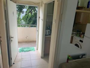 a kitchen with a door open to a kitchen with a tile floor at משמר הגבול 9 דירה 4 in Haifa