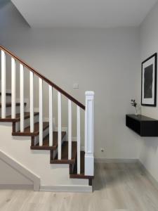 a staircase in a home with white walls and wood floors at Stunning Bosphorus View Daire 12 in Istanbul