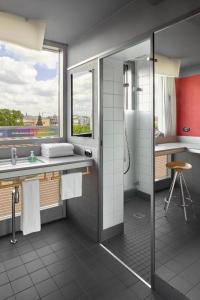 a bathroom with a shower and a sink at Casa Camper Berlin in Berlin