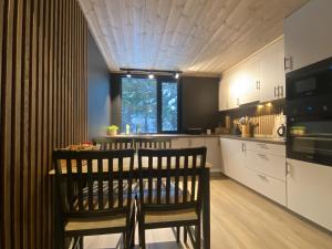 a kitchen with a table and two chairs in it at Newly renovated apartment with a central location in Geilo