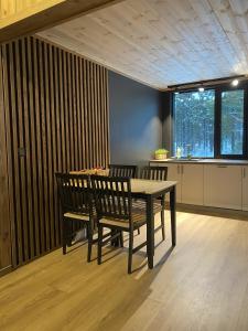a dining room with a table and two chairs at Newly renovated apartment with a central location in Geilo +8 photos