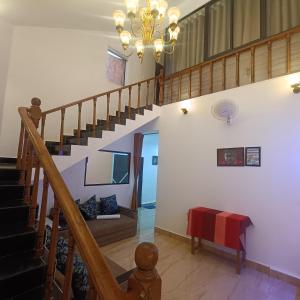 a staircase in a home with a chandelier at VILLA CASA SUMANJO (3BHK) in Calangute