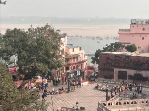 a group of people walking down a city street at Baba Vishwanath Residency in Varanasi